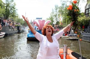06-08-2009 SHOWBIZZ; GAY PRIDE AMSTERDAM TREKT MEER DAN 600.000 BEZOEKERS. Een giga festijn de 2009 Gay Pride in Amsterdam, duizenden bootjes, honderdduizenden bezoekers en een Sinterklaas die na het uur moest worden opgenomen met wel heel vreemde verschijnselen, en als wij de media moeten geloven na het drinken van een wodkaatje. Wij weten beter want wij waren er smorgens vroeg al bij,plaats van alle verrassingen De Westerdok haven.Toen was het nog niet heet, er waaide een heerlijk windje en de aanwezige BNers hadden er zin in, zelfs Sint Nicolaas of te wel Gordon. Menig drankje gleed naar binnen voordat de boten vertrokken richting de Prinsengracht. Als dat maar goed gaat dacht ik nog. En het ging niet goed, Sint Nicolaas werd witter dan wit en werd lieftallig verzorgd door de dames met ijsklontjes. Niks hitte beroerte of een schommelende boot, zware mijter of Sinterklaaspak van velours. Gordon droeg een wit katoenen pantalon en een katoenen hemt met inderdaad een mantel die helemaal los hing. Niks bevangen door de hitte, andere oorzaken dwongen hem tot stoppen van de Stoompoot boot. Sinterklaas werd afgevoerd in een ambulance voor verder onderzoek. Zondag avond was Gordon weer van de partij om de Gay Pride party te besluiten met een optreden. Al met al weer een zeer bewogen weekend voor vele mensen.
foto: Albert den Iseger