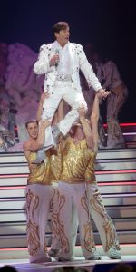 29-12-2007 SHOWBIZZ; CONCERT GERARD JOLING STOUT EN NIEUW 2007. Donderdag en Vrijdagavond was het weer een Joling feestje in de Ahoy. Dat Gerard zich thuis voelt in de Ahoy was direct te merken, de stemming zat er direct in na de eerste muzieknoten. De zanger was soms niet goed bij stem en moest het achtergrondkoortje het opvangen of Gerard liet het publiek zingen. Zijn vaak eigenzinnige grapjes waren meer dan eens op het randje en daar kan Dre Hazes van meepraten, zo vroeg Gerard aan Dre of ook alles lekker met hem meegroeide. Naast Dre Hazes trad ook Bonnie St.Clair op die opmerkelijk de tribunes deed schudden. Maaike en Tessa en Bearforce One deden hun eigen ding maar waren geen toevoeging tot de Joling Show. De knuffelberen van Bearforce One stonden volgens velen slecht te playbacken. De uitstraling van de show was niet echt Stout te noemen en had allemaal wat brutaler gemogen, ondanks de vele glitterpakken en veren jassen, daar maakt men de show niet Stout mee.De beloofde pikante en Stoute show heb ik niet gezien. Wel een echt Joling concert met een hoog Gaygehalte in het repertoire. Al met al was het een gezellig avondje uit voor de Joling fans al bestaan die voornamelijk uit Oma-s travestieten en studentes die in de pauze ook uit hun dak gingen toen de DJ een hit draaide van Frans Bauer.
foto: Albert den Iseger.