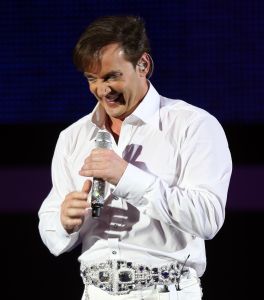 29-12-2007 SHOWBIZZ; CONCERT GERARD JOLING STOUT EN NIEUW 2007. Donderdag en Vrijdagavond was het weer een Joling feestje in de Ahoy. Dat Gerard zich thuis voelt in de Ahoy was direct te merken, de stemming zat er direct in na de eerste muzieknoten. De zanger was soms niet goed bij stem en moest het achtergrondkoortje het opvangen of Gerard liet het publiek zingen. Zijn vaak eigenzinnige grapjes waren meer dan eens op het randje en daar kan Dre Hazes van meepraten, zo vroeg Gerard aan Dre of ook alles lekker met hem meegroeide. Naast Dre Hazes trad ook Bonnie St.Clair op die opmerkelijk de tribunes deed schudden. Maaike en Tessa en Bearforce One deden hun eigen ding maar waren geen toevoeging tot de Joling Show. De knuffelberen van Bearforce One stonden volgens velen slecht te playbacken. De uitstraling van de show was niet echt Stout te noemen en had allemaal wat brutaler gemogen, ondanks de vele glitterpakken en veren jassen, daar maakt men de show niet Stout mee.De beloofde pikante en Stoute show heb ik niet gezien. Wel een echt Joling concert met een hoog Gaygehalte in het repertoire. Al met al was het een gezellig avondje uit voor de Joling fans al bestaan die voornamelijk uit Oma-s travestieten en studentes die in de pauze ook uit hun dak gingen toen de DJ een hit draaide van Frans Bauer.
foto: Albert den Iseger.
