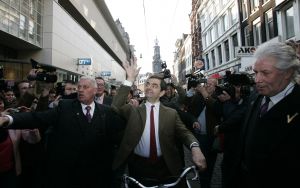 27-03-2007 SHOWBIZZ; ACTEUR ROWAN ATKINSON OF MR.BEAN WAS IN AMSTERDAM VOOR FILM PREMIERE. Maandagavond kwam Rowan Atkinson als zijn typetje Mr. Bean op de fiets naar de premiere van zijn nieuwste film. Hij reed van de Munt naar de Reguliersbreestraat en stapte af voor de deur van Tuschinki. Echter niet zonder problemen, vele fotografen, filmploegen  en bijzonder veel publiek zorgden hier en daar voor chaos, net als in zijn nieuwste film waar hij van Londen naar de Riviere reist. Bekend Nederland liet het massaal afweten, welgeteld waren er slechts 4 B ners komen opdagen.
Na de presentatie van de film sloop de komiek via de achterdeur naar buiten en werd vlug afgevoerd naar het Amstel hotel.
foto: Albert den Iseger.
